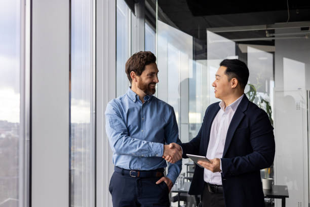 istock Professional businessmen shaking hands in office, colleagues and partners collaboration 2148278545
