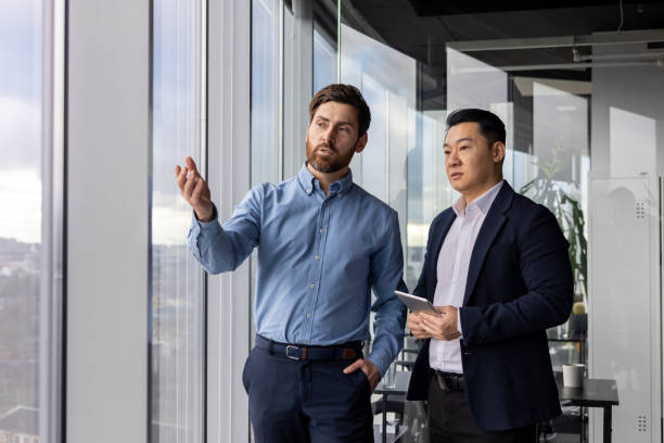 istock Professional corporate businessmen discussing work in modern office setting 2148278608