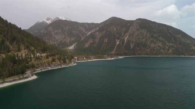 Aerial view Plansee lake in Austrian Alps. See Tirols Plansee. Plansee im Bezirk Reutte, Tirol, Osterreich innerhalb der Ammergauer Alpen. Large clear lake in Austria. Reservoir in mountains.