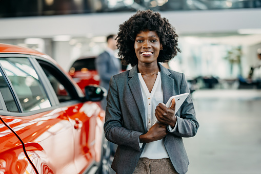 This seller, a young African American woman, becomes an ambassador of auto elegance, her approach personalizing the car buying process with finesse and detailed knowledge