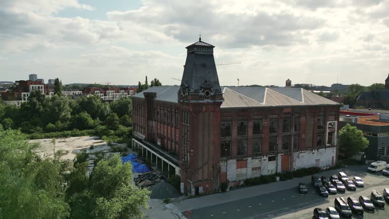 Wide Circular Aerial of Historic Abandoned Building With Clock Tower in Ghent, Belgium