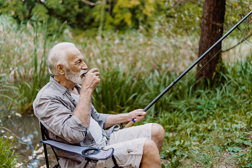 Senior man fishing alone