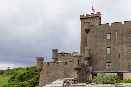 Dunvegan - United Kingdom. May 23, 2023: Overcast skies loom over Dunvegan Castle, a sturdy fortress with robust towers and battlements