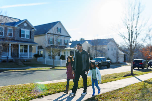 istock Father walks his school aged daughters to school 2148281229