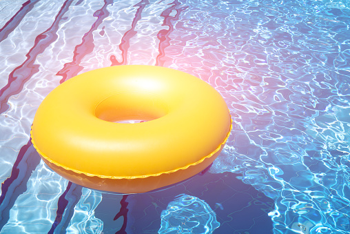 inflatable yellow inner tube floating in clear blue waters