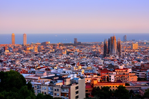 Barcelona cityscape with Sagrada Familia and Mediterranean Sea in background. Sunset city view of Barcelona, Spain.