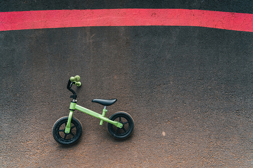 photo of little boy skater style bike on pump track circuit