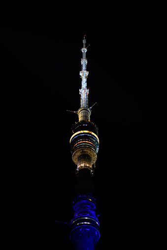 Moscow, Russia - 16 Sep 2017: A breathtaking night view of a towering communication tower, adorned with lights that pierce the darkness, symbolizing human ingenuity and the marvel of modern engineering.