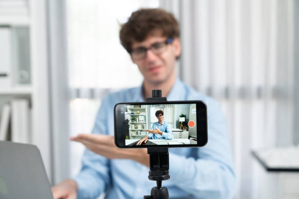 istock Influencer using phone streaming online focusing phone with portrait. Gusher. 2148283521