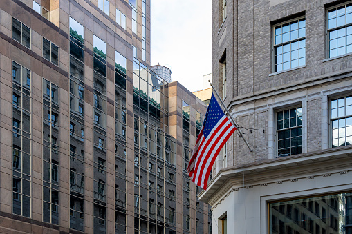 A shot of the US flag and the Intercontinental hotel in downtown Miami, Florida on October 2016