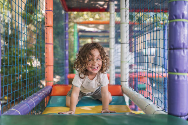 istock Happy little boy playing on a playground outside in natural light 2148284189