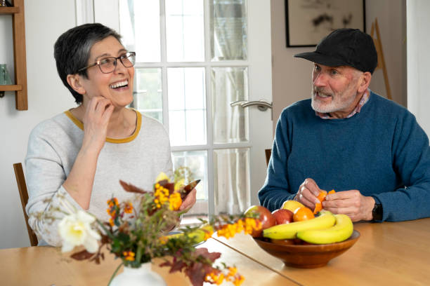 istock Husband and wife eating fruit, being happy and having a conversation 2148284228