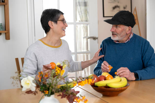 istock Husband and wife eating fruit, being happy and having a conversation 2148284229