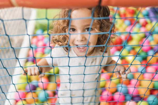 istock Happy little boy playing on a playground outside in natural light 2148284230
