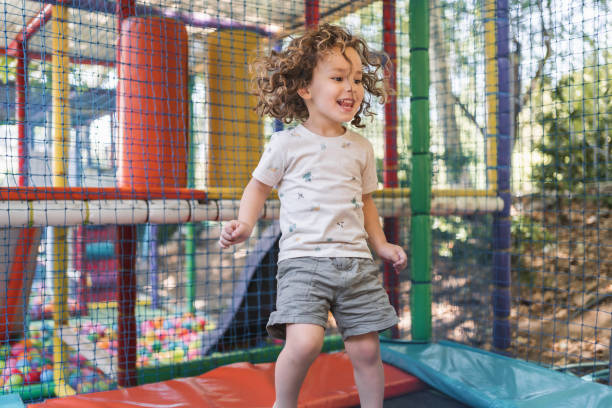 istock Happy little boy playing on a playground outside in natural light 2148284237
