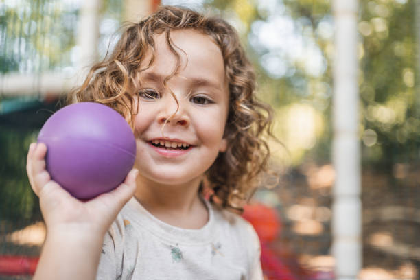 Happy little boy playing on a playground outside in natural light