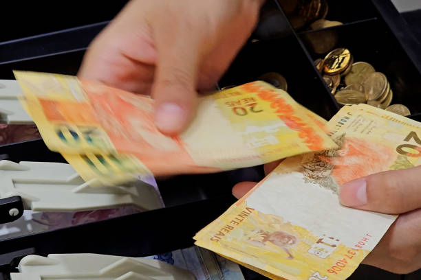 istock Counting 20s to put back in the drawer 2148286423