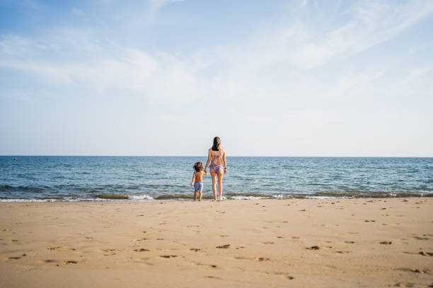 istock mother and son holding hands looking at the atlantic ocean 2148286438