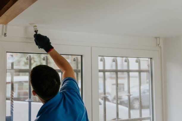 istock A young oriental man paints a window opening with a brush. 2148286678