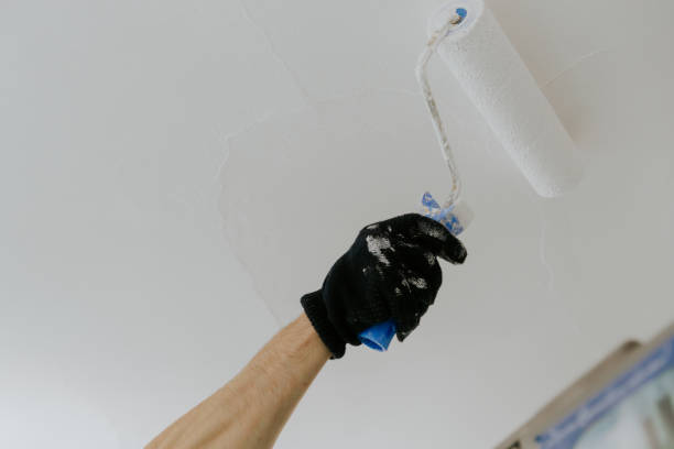 istock The hand of an unrecognizable man paints the ceiling . 2148286695