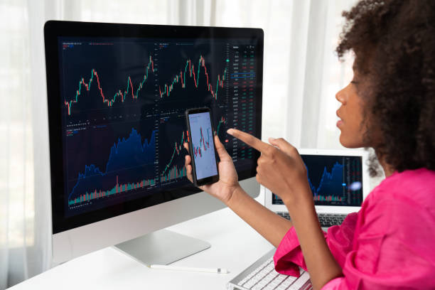 istock African woman blogger looking on computer screen and smartphone. Tastemaker. 2148287464