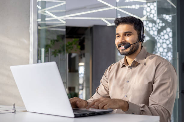 istock Confident man working with headset and laptop in office 2148287683