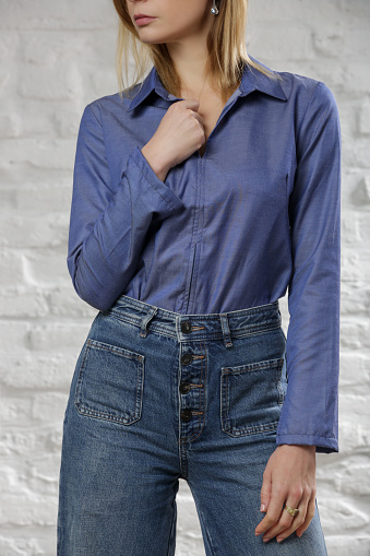 Studio photo of woman wearing cool denim on denim outfit