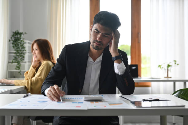 istock Stressed business man feeling exhausted, having headache, worried about problem at work. 2148288188