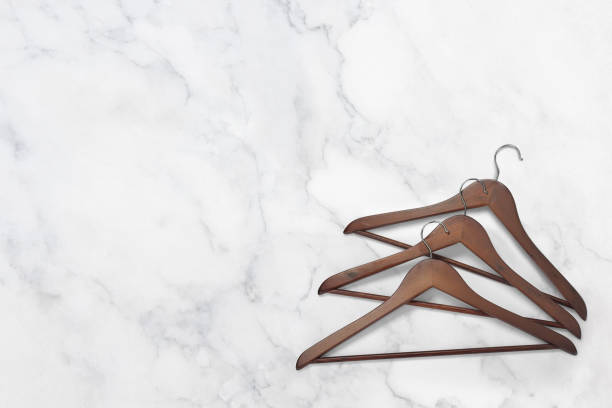 Wood cloth hangers on a white marble background