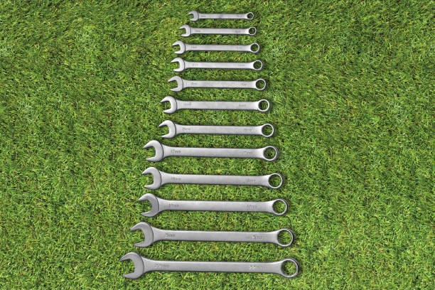 Wrench and screw-nut on set on a grass background