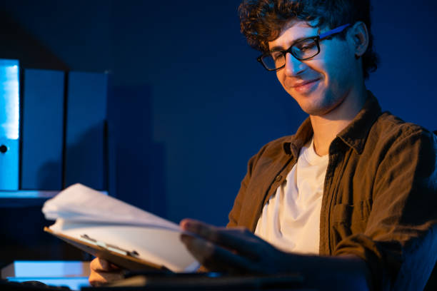 istock Young businessman reading design thinking on paper for new project. Gusher. 2148289718