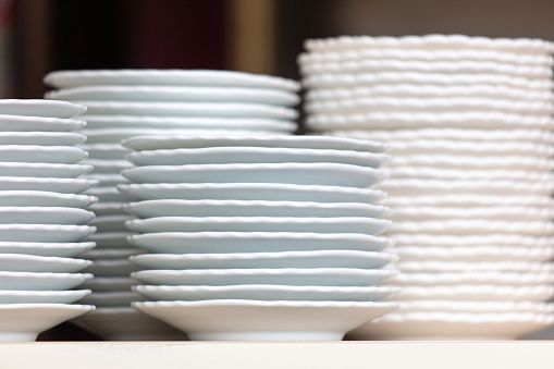 Pyramid of white plates in the kitchen.
