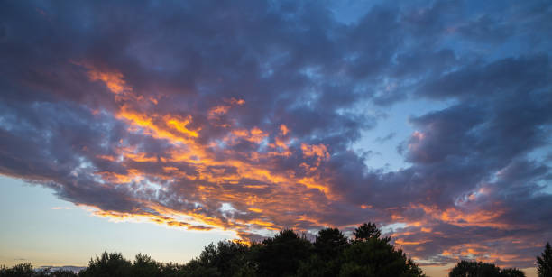 istock the fire clouds in the sky, orange, blue, background 2148290664