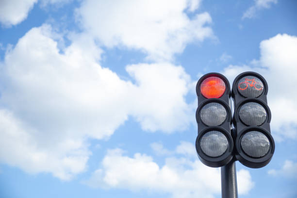 istock the traffic light in the background of blue sky, red light 2148290698