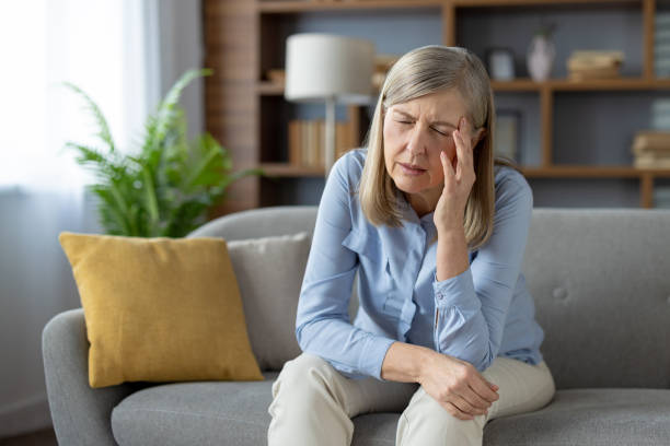 istock Upset mature woman sitting alone on a sofa at home 2148290728