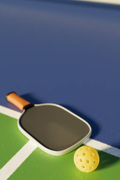 istock A pickleball racket and ball lie on the court line 3D rendering. 2148291063