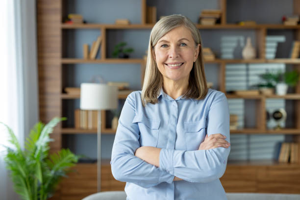 istock Confident mature woman smiling in a home office setting 2148291257