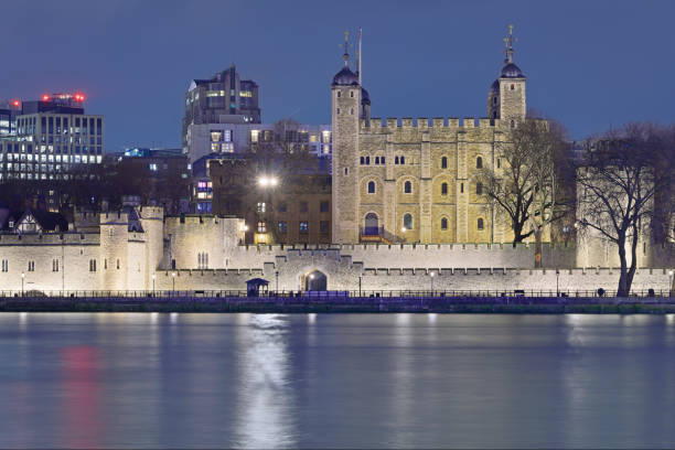 Night time view of the Tower of London on the river Thames (England).