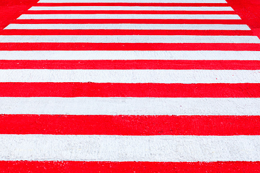 Low angle view oif Red and white colored zebra crossing