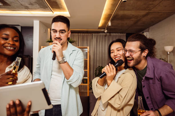 istock Multiracial group of friends having karaoke night. 2148292992