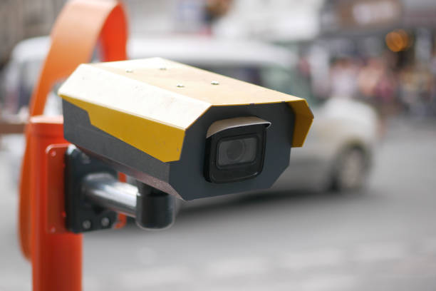 Urban security camera placements near vehicles captured in video footage.
