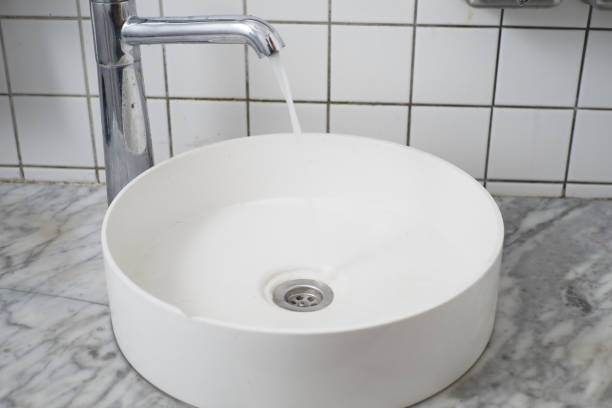 water pouring from a faucet tap slow motion .