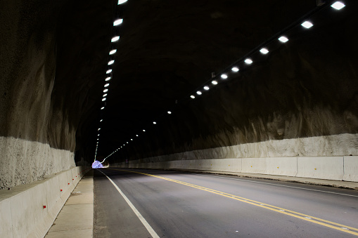 Alphalt road in a dark tunnel in Mendoza, Argentina.