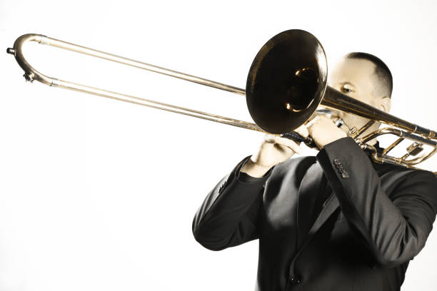 istock Trombone player. Trombonist playing jazz musician isolated on white 2148295232