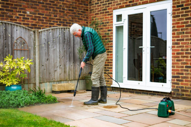 istock Senior man cleaning patio tiles using pressure washer 2148295317