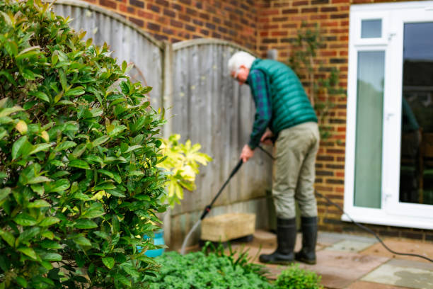 istock Senior man cleaning patio tiles using pressure washer 2148295319