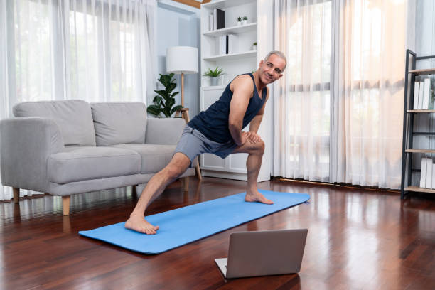istock Active and fit senior man warmup and stretching before home exercising. Clout 2148295334
