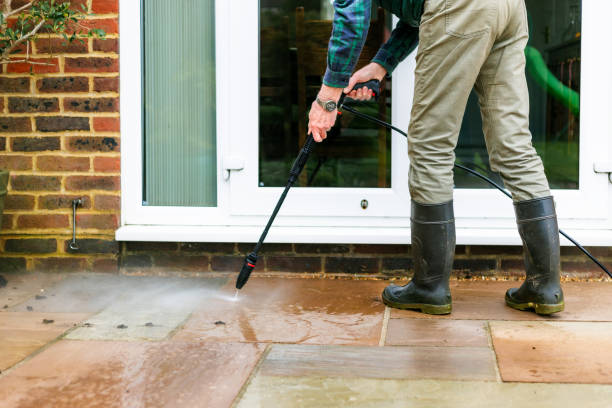 istock Senior man cleaning patio tiles using pressure washer 2148295337