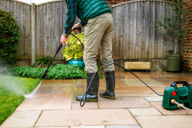istock Senior man cleaning patio tiles using pressure washer 2148295341