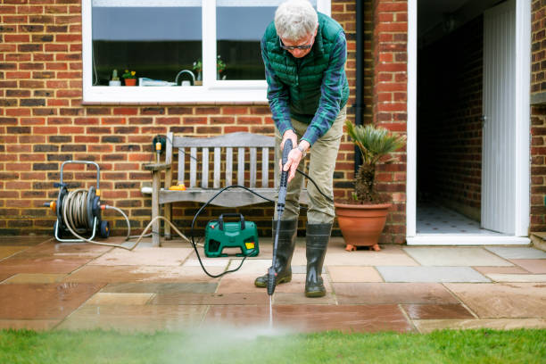 istock Senior man cleaning patio tiles using pressure washer 2148295394